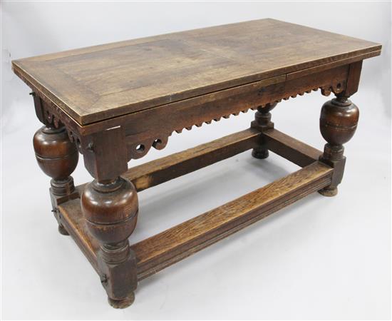 A 17th century style oak crossbanded draw leaf refectory style table, extends 8ft 9in. x 2ft 4in x 2ft 7in.